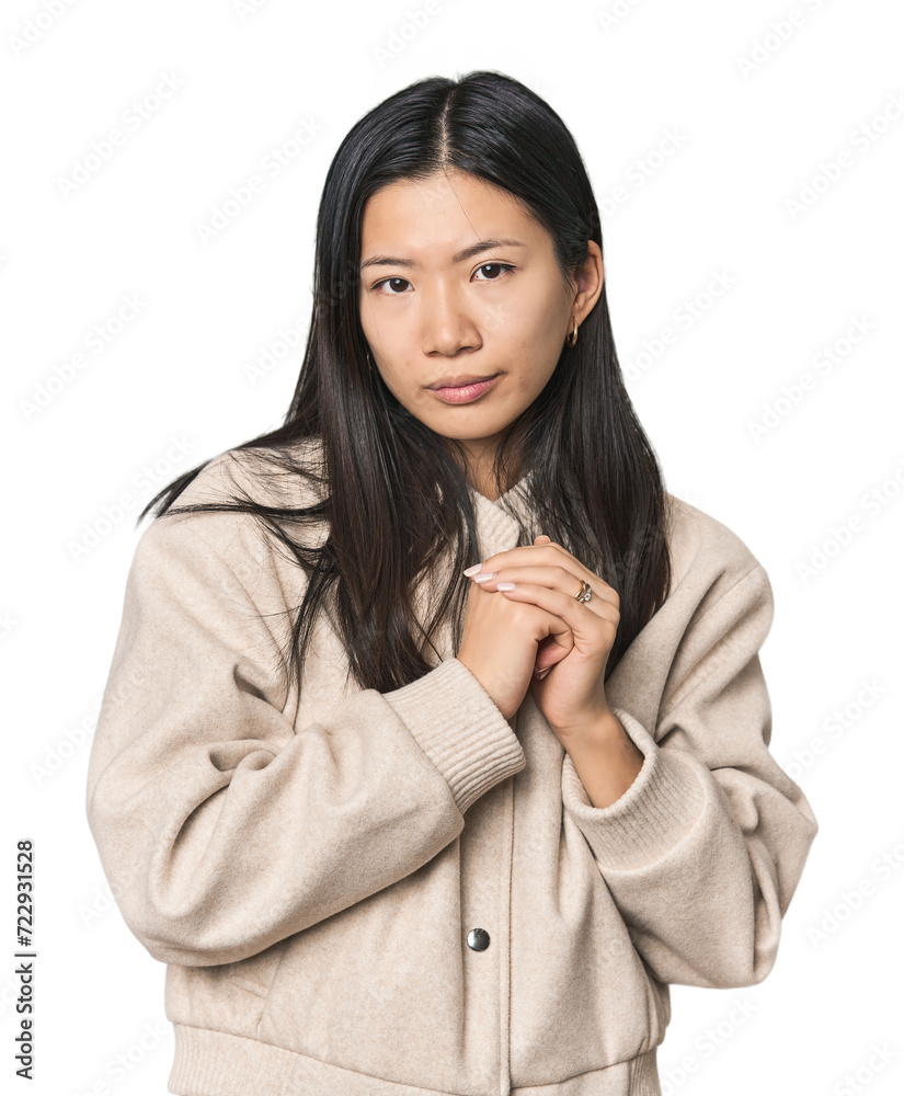 Young Chinese woman in studio setting scared and afraid. Young Chinese woman in studio setting scared and afraid.