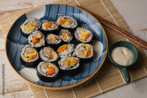 Gimbap, also romanized as kimbap, is a Korean dish made from cooked rice and ingredients such as vegetables, fish, and meats. Sushi roll.