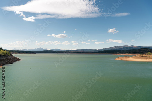 Green reservoir lake on a summer day. Aguilar de Campoo, Spain