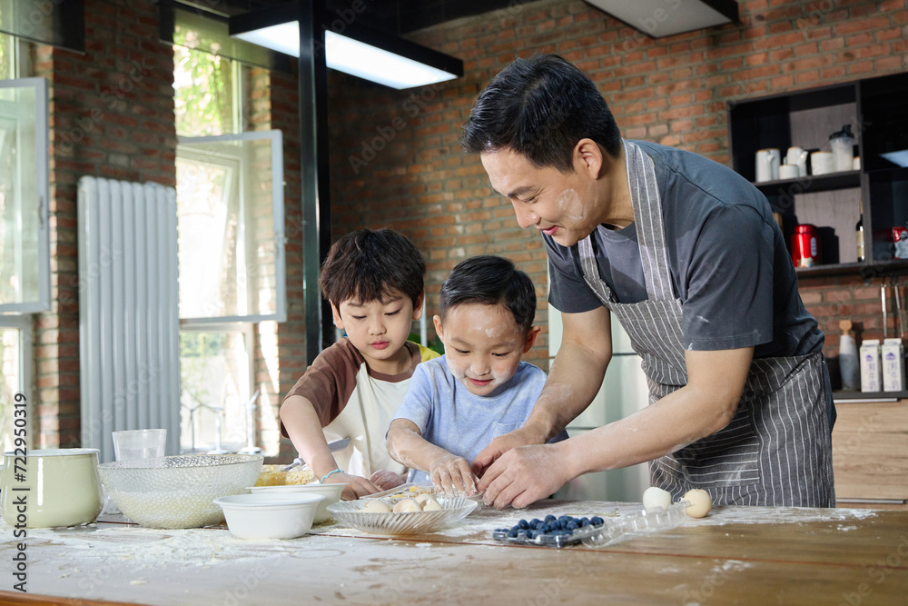 Father baking with his two sons Father baking with his two sons
