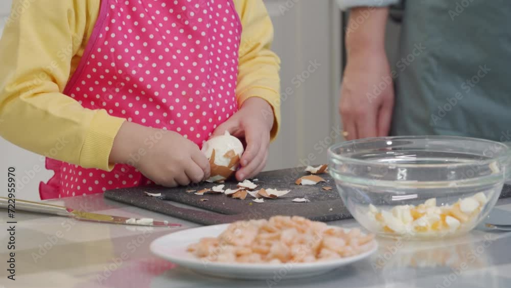 Mother with child preparing dinner together in modern kitchen at home, little boy helping mom cooking vegetable salad with shrimp. Mother with child preparing dinner together in modern kitchen at home, little boy helping mom cooking vegetable salad with shrimp.