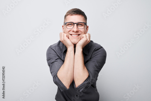 Portrait man smiling joyfully touching happy shocked face isolated on white studio background, advertising banner.