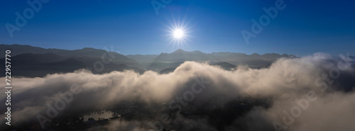 Panoramic sunrise above the cloud and misty mountain at the viewpoint of Wat Phra That Doi Kongmu temple, Mae Hong Son province, Thailand  © Akarawut