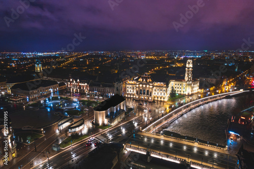 Midnight Symphony: A Captivating Aerial Glimpse of Oradea, Romanias Vibrant Cityscape Illuminated by Night © Damian