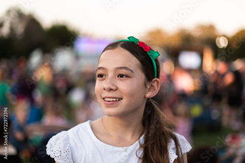 girl smiling in a christmassy hair band at Christmas carols