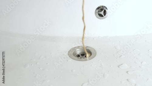A man takes wet hair out of the sink and bathroom with his hand. sewage treatment.