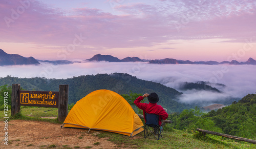 Man tourist with his orange tent in Mae Moei Nationnal Park border of Thailand and Myan Mar, Tak province Thailand.