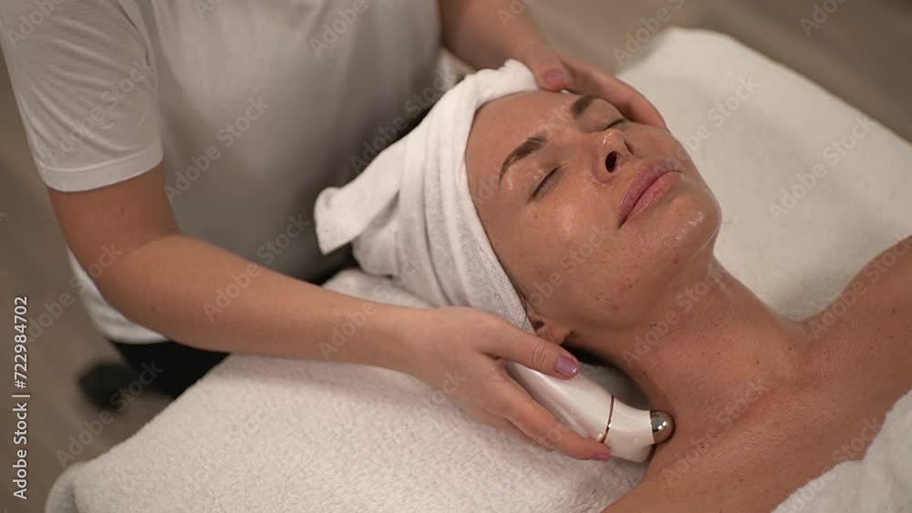 a woman receives a massage. microcurrents for the body. Slow motion video. High quality video in 4K format. a woman receives a massage. microcurrents for the body. Slow motion video. High quality video in 4K format.
