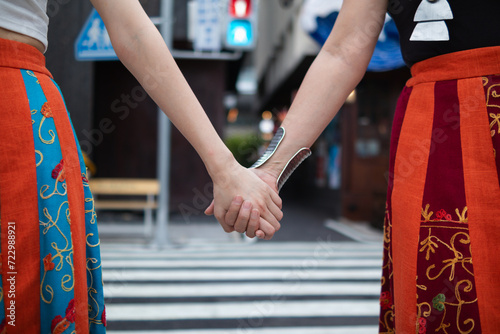 lgbtq couples openly walk hand in hand down street to show lgbtq rights and freedoms of love for each other. lgbtq couples walk hand in hand down street show their love and friendship for each other