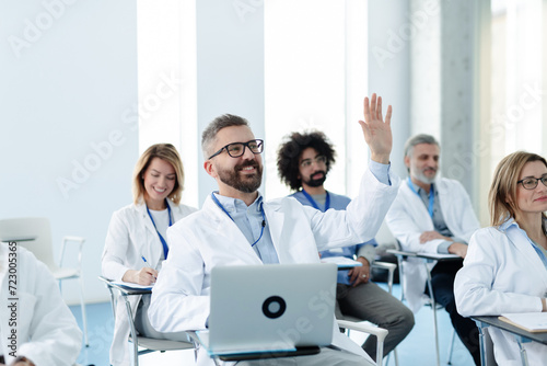 Φωτογραφία Medical team on conference, doctor asking question to speaker