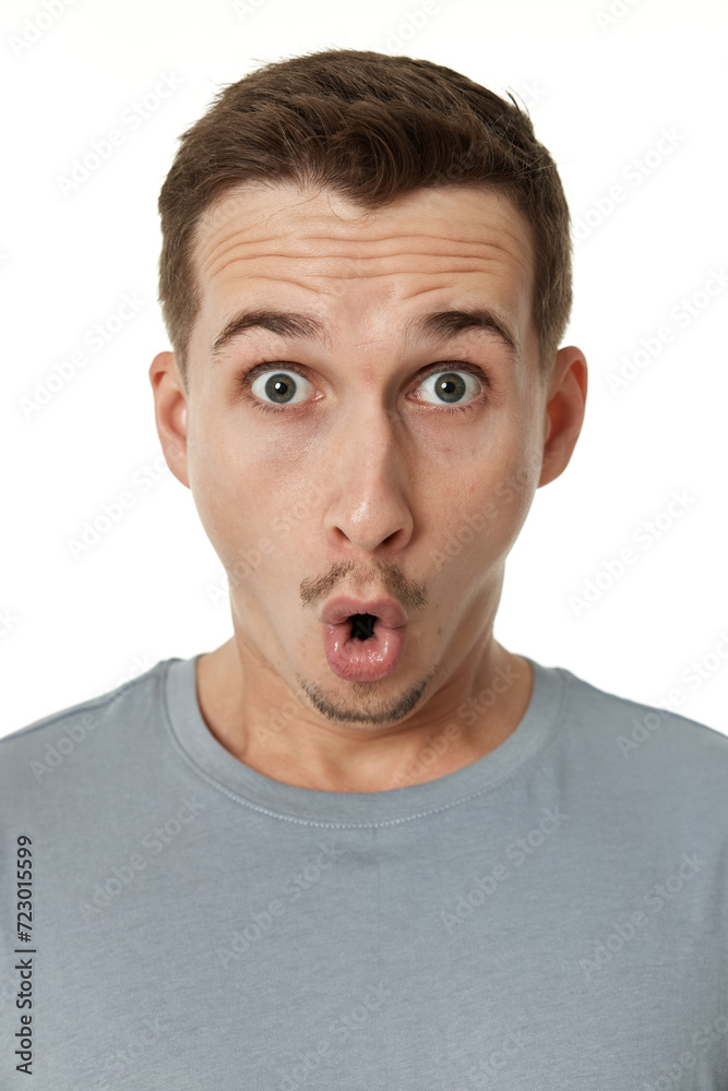 surprised guy looking at camera on white studio background surprised guy looking at camera on white studio background