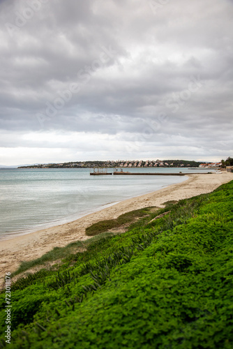 Beach and ocean with cloudy sky in the background. Beautiful landscape.