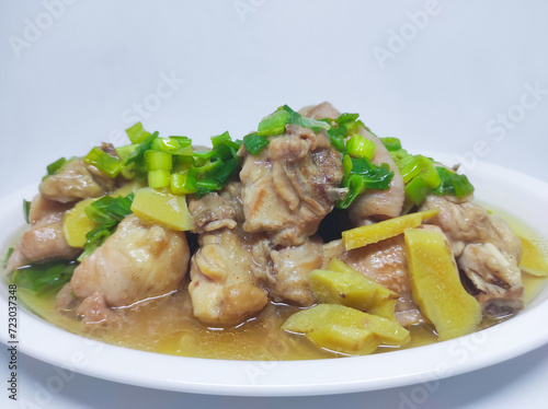 Steamed chicken meat with ginger served on plate isolated on white background