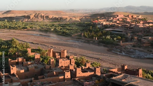 Draa river flowing by the Kashbas of an oasis town sorrounded by palm trees in the Sahara Desert, Ait Ben Haddou in Morocco photo