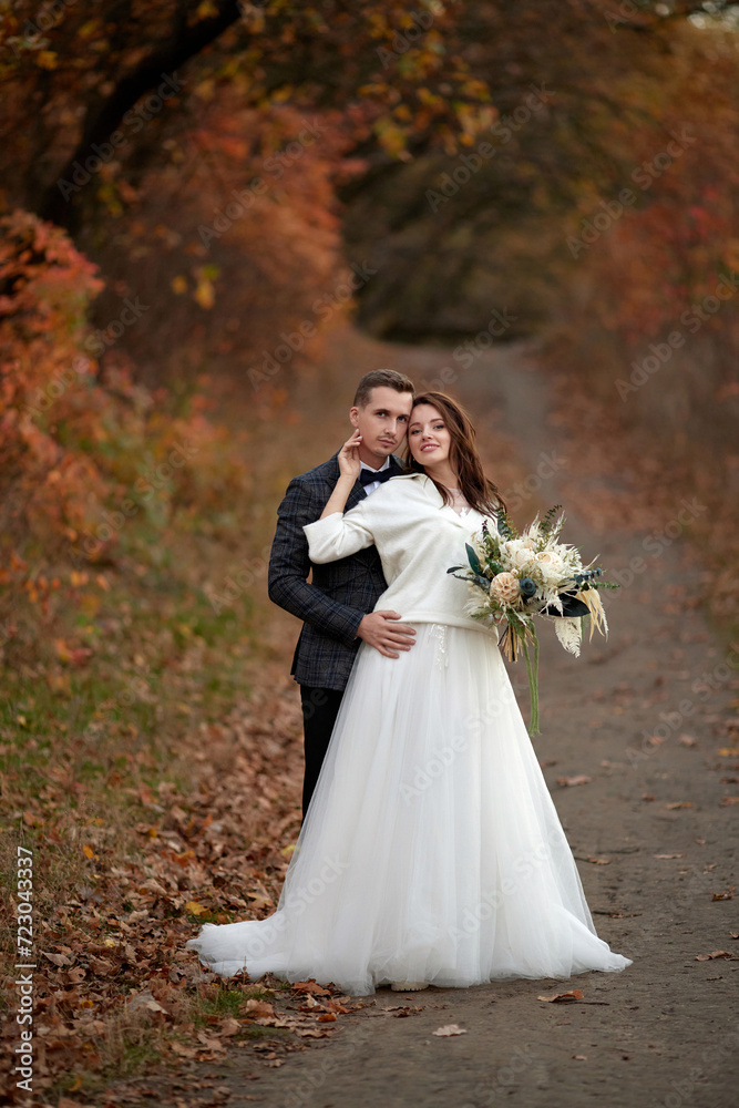 happy bride in white wedding dress and groom standing outdoor on natural background, Full length