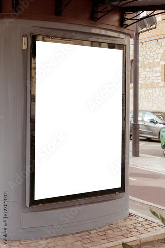 Empty outdoor advertisement space on a kiosk, nestled on a city street, ideal for marketing and urban design. Copy space for your picture, text. Vertical billboard mock up.