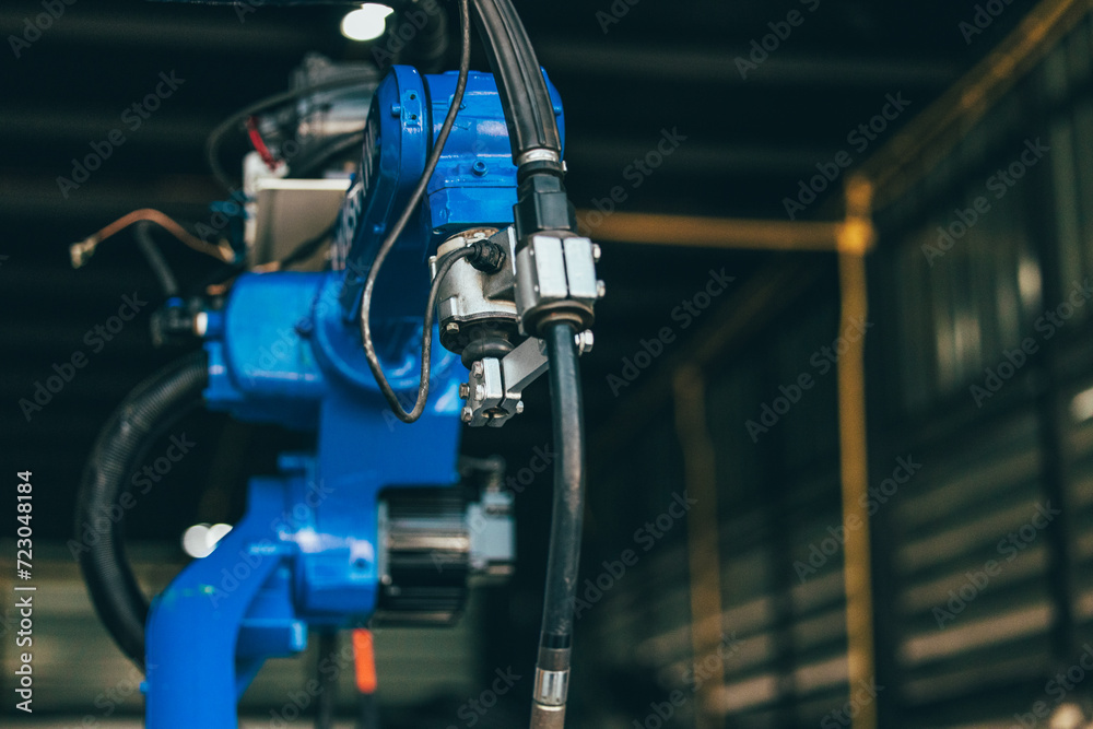 Automated Robotic Arm in Industrial Factory. Automated Robotic Arm in Industrial Factory.