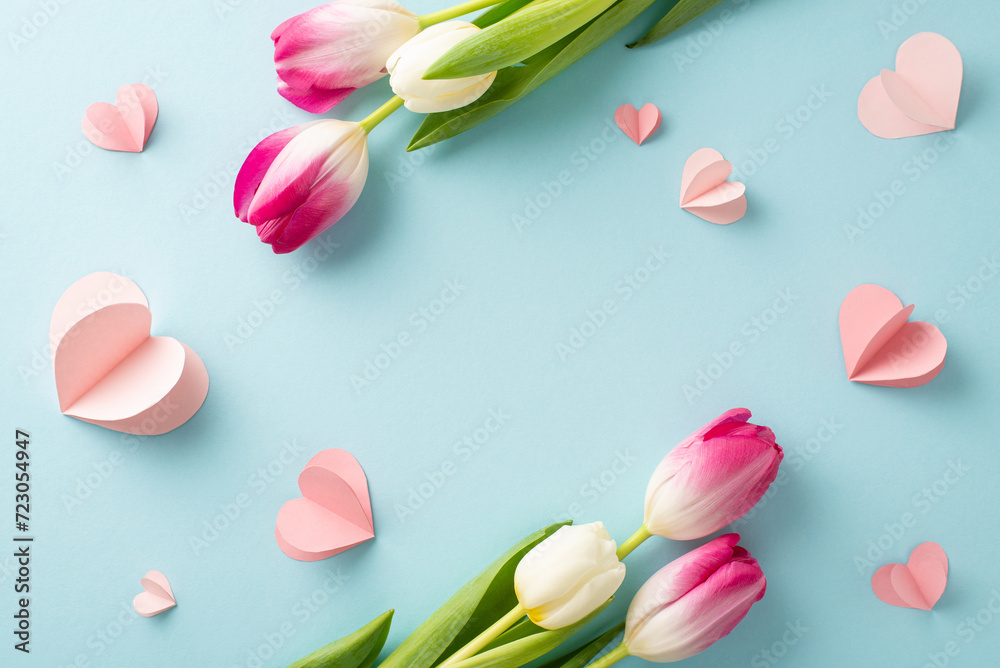 Radiant tulip love! Capture the essence of Woman's Day with a top view photo of vibrant tulips and heart details on a pastel blue background. Customize with your own text or advert for a special touch Radiant tulip love! Capture the essence of Woman's Day with a top view photo of vibrant tulips and heart details on a pastel blue background. Customize with your own text or advert for a special touch