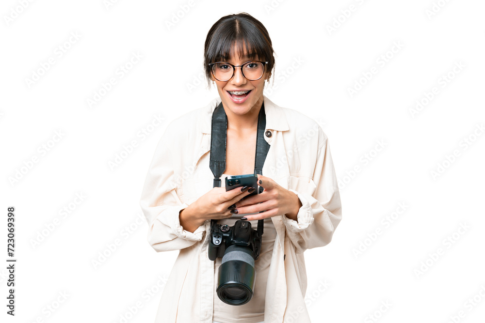 Young photographer caucasian woman over isolated chroma key background surprised and sending a message Young photographer caucasian woman over isolated chroma key background surprised and sending a message