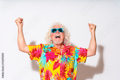 Cheerful senior man cheering against white background photo