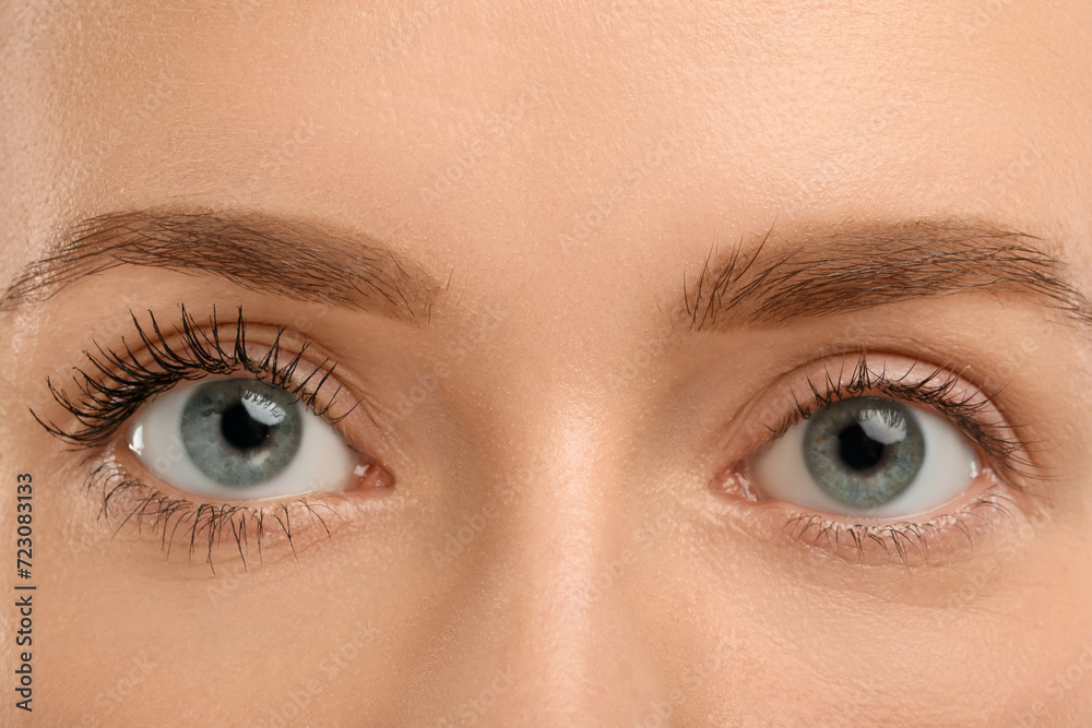 Fototapeta premium Woman showing difference in eyelashes length after mascara applying, closeup
