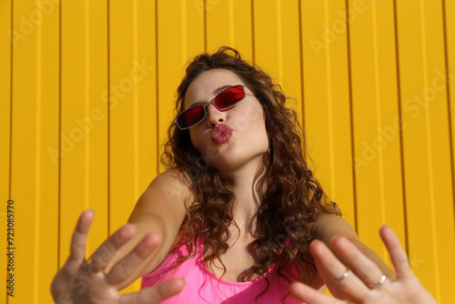 Beautiful woman puckering lips in front of wall
