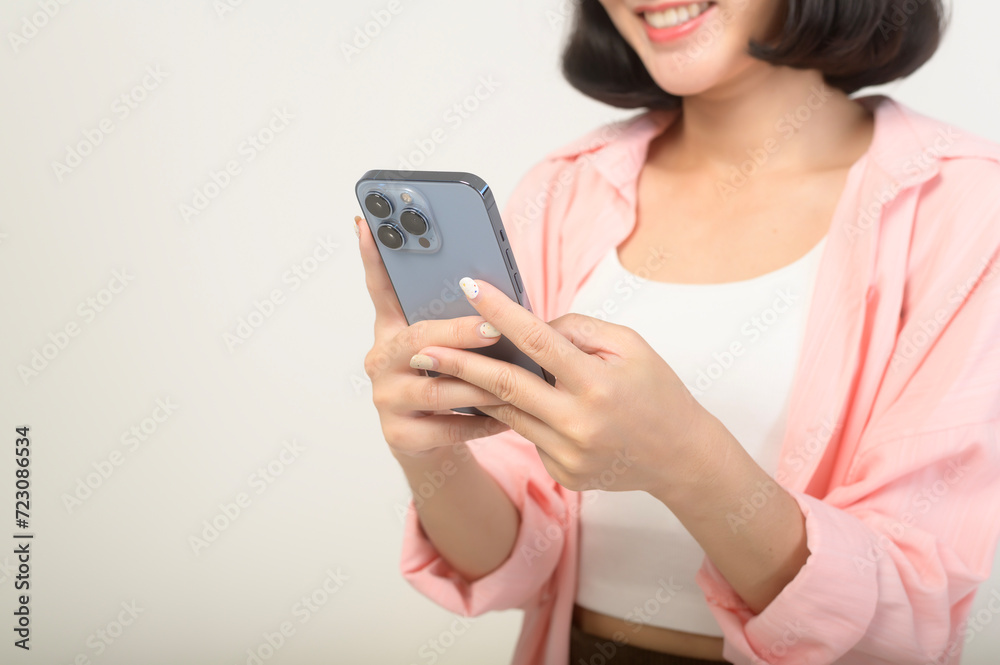 Young asian woman using smartphone over white background, technology concept Young asian woman using smartphone over white background, technology concept