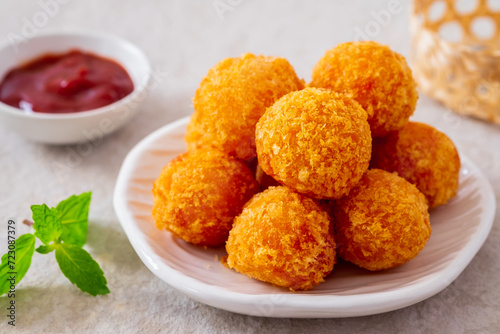 Deep fried cheese balls on plate and ketchup