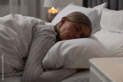 Menopause. Woman sleeping in bed at home