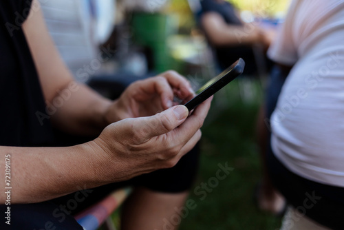 Photo of a hands and closeup of woman on a phone networking on social media  mobile app or the internet. Technology  nature and female person typing a text message on cellphone in the countryside.