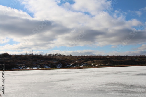 A snowy landscape with a cloudy sky