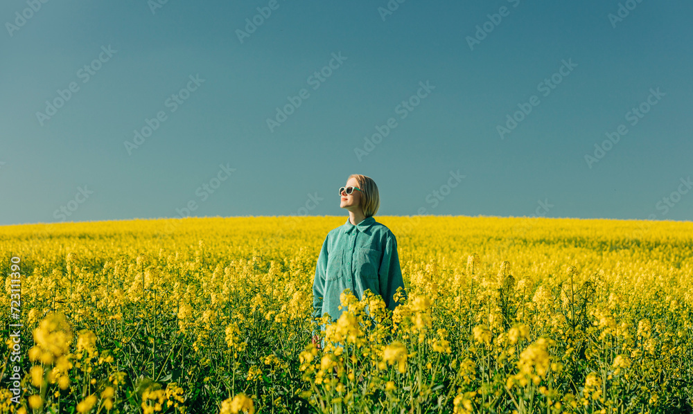 © VISTA by Westend61 - Woman standing amidst flowers in rapeseed field