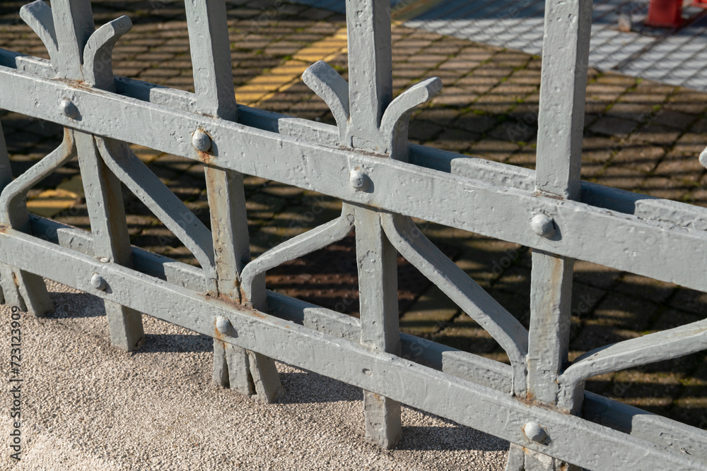 wrought iron railing, old factory gate with allegorical elements fixed