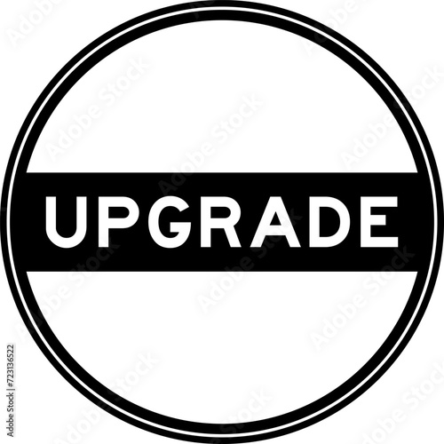 Black color round seal sticker in word upgrade on white background