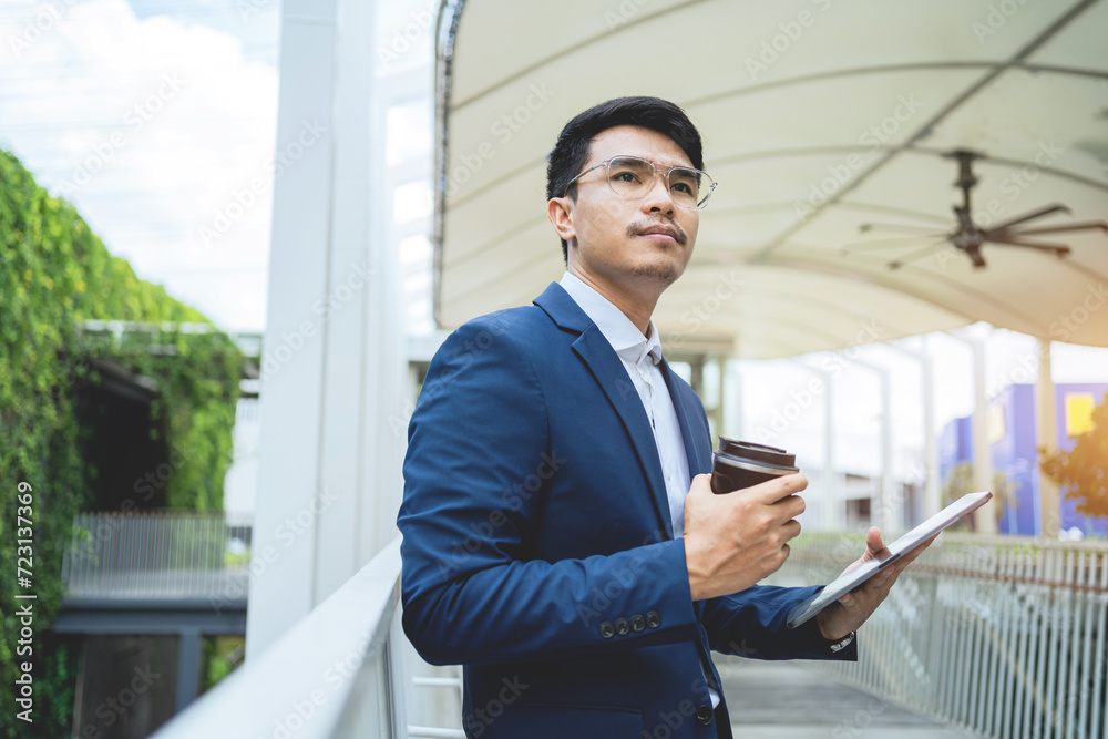 Asian businessman uses a laptop computer to work in an office building. Successful financial business ideas. Asian businessman uses a laptop computer to work in an office building. Successful financial business ideas.