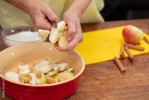 Hands cutting apples with a knife. Cooking apple pie.