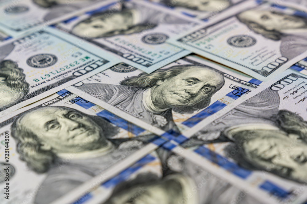 Many 100 USD banknotes set with heads of Benjamin Franklin one to another Many 100 USD banknotes set with heads of Benjamin Franklin one to another