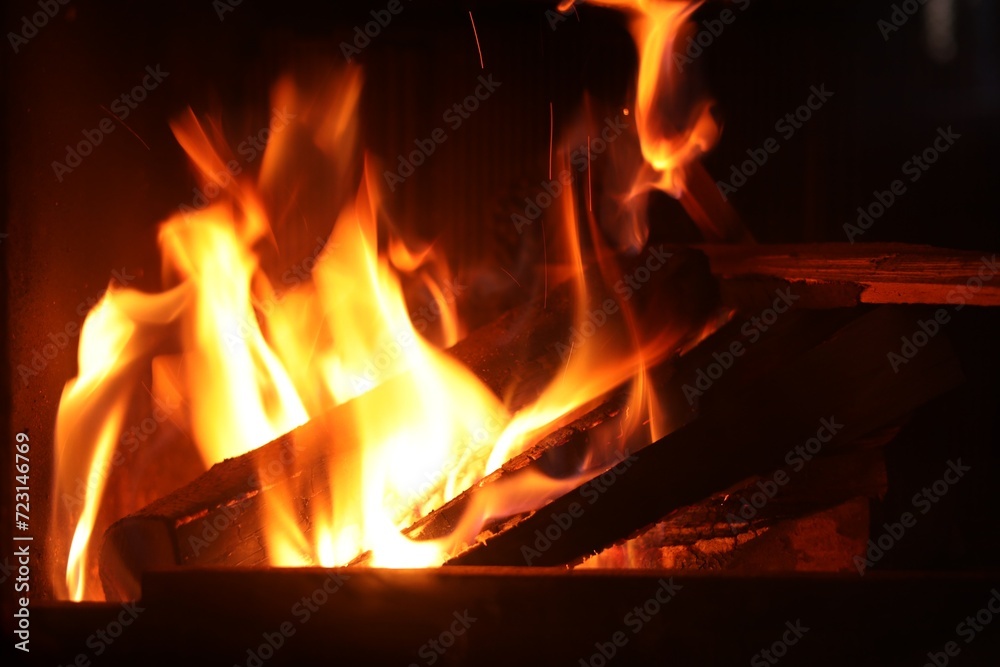 Bonfire with burning firewood on dark background Bonfire with burning firewood on dark background