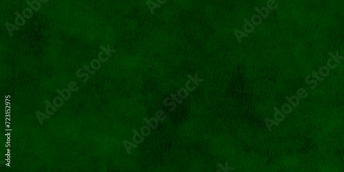 Closeup of rough green textured background. Dark green wall texture for designer background. Artistic plaster. Rough lighted surface. Abstract pattern. Bright backdrop. Raster image.