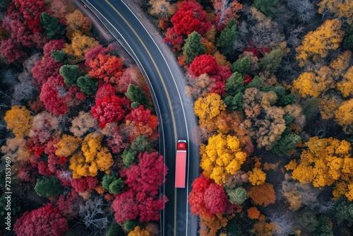 Bird s eye view of truck on winding road with autumn trees
