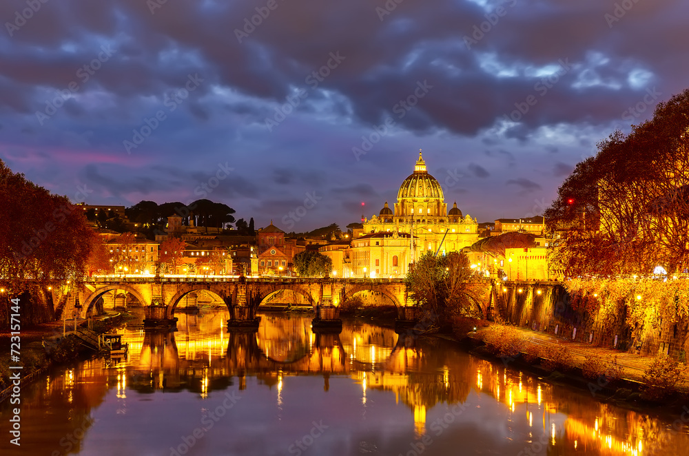 Beautiful vibrant night image of St. Peter's Basilica, Ponte Sant Angelo and Tiber River at dusk in Rome, Italy.