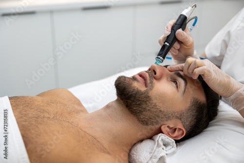 Man having cosmetological procedures in a beauty clinic