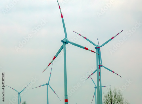 Wind turbine station windmill park next to the road in Austria in cloudy weather.