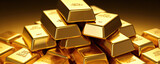 Polished gold bars neatly stacked, shining brilliantly on a dark, reflective surface