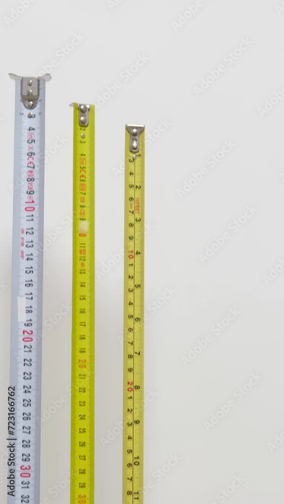 Using measuring tape to check dimensons of furniture Detail of numbers on a ruler apples are unlikely advertising Green background chromakey copy space Using measuring tape to check dimensons of furniture Detail of numbers on a ruler apples are unlikely advertising Green background chromakey copy space
