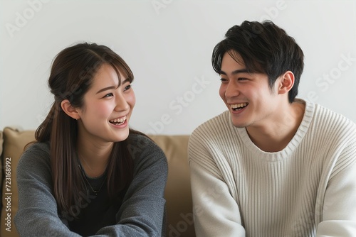 自宅のソファで談笑する日本人カップル・夫婦・兄弟（友達・恋人・自宅デート）