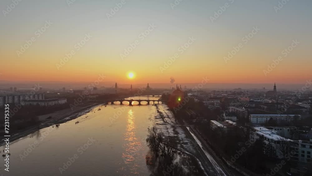 Total Aerial view over the Dresden Elbe at sunset in the winter with sun backlit. Drone move left. Total Aerial view over the Dresden Elbe at sunset in the winter with sun backlit. Drone move left.
