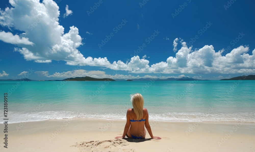 Obraz premium Young pretty woman sunbathing on the amazing sandy beach. Happy holiday theme.