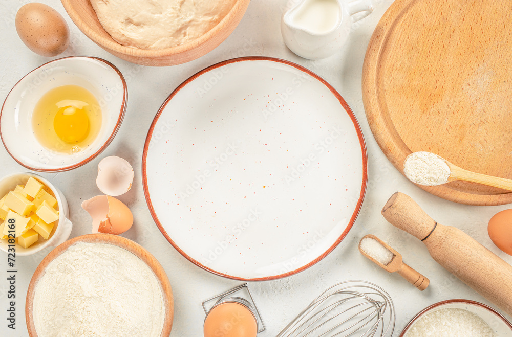 ingredients of baking and cooking bread pastry or cake flour sugar milk eggs and butter on a white background top view. copy space ingredients of baking and cooking bread pastry or cake flour sugar milk eggs and butter on a white background top view. copy space