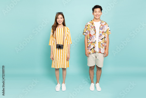 Portrait of young Asian couple smiling in summer outfit isolated on green background, Two people concept